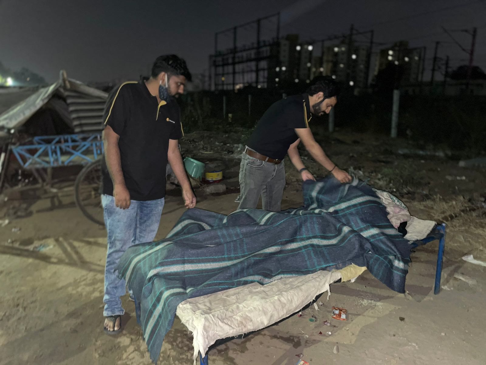 Gatewayites laying a blanket for someone sleeping rough on a winter night